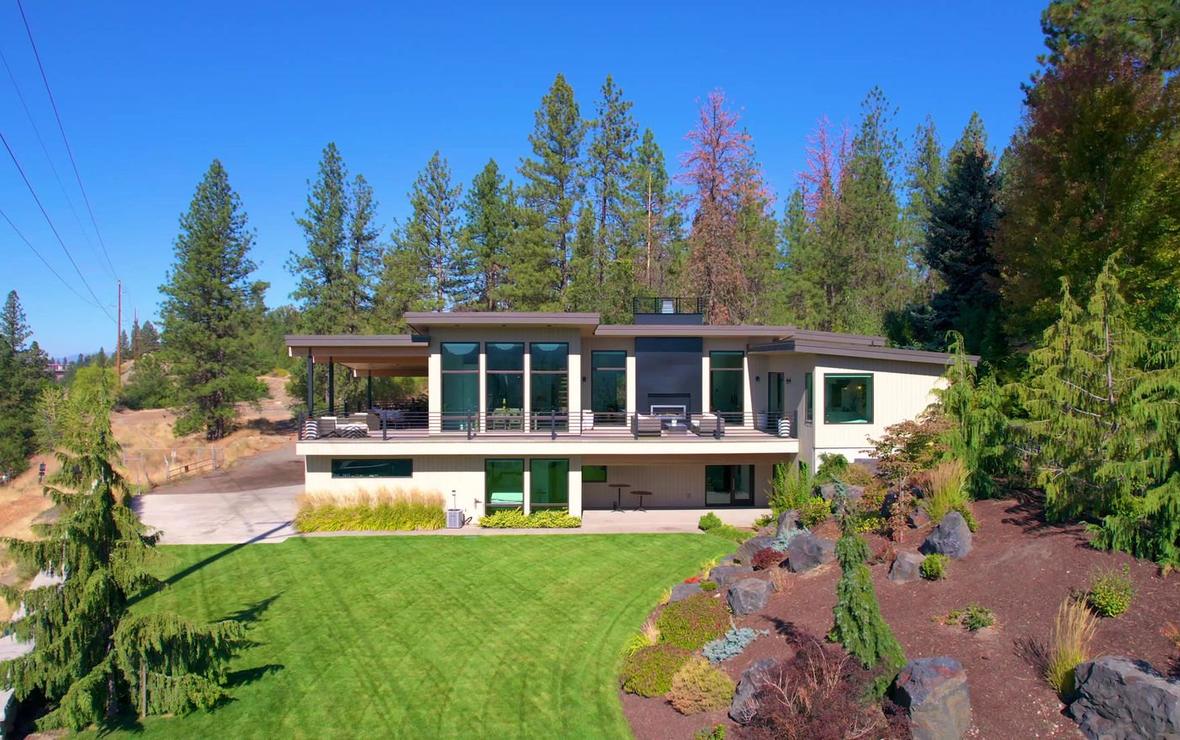 Contemporary home with a manicured lawn, photographed from the garden.