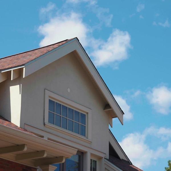 Craftsman-style home exterior against a clear blue sky.