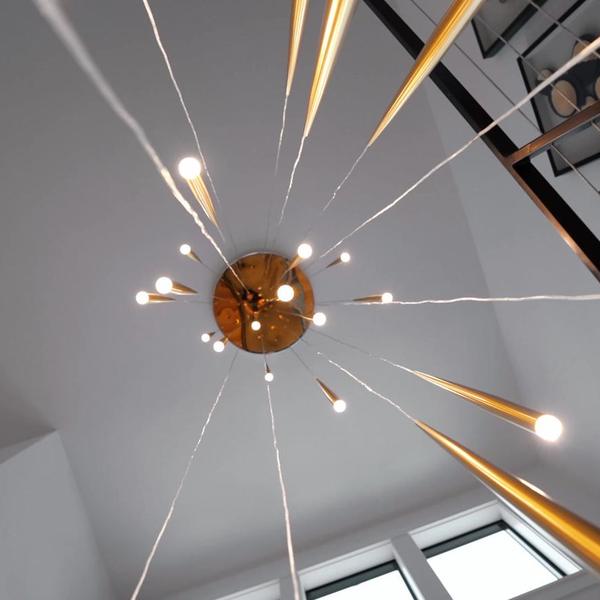 Architectural detail of a vaulted ceiling and pendant light.